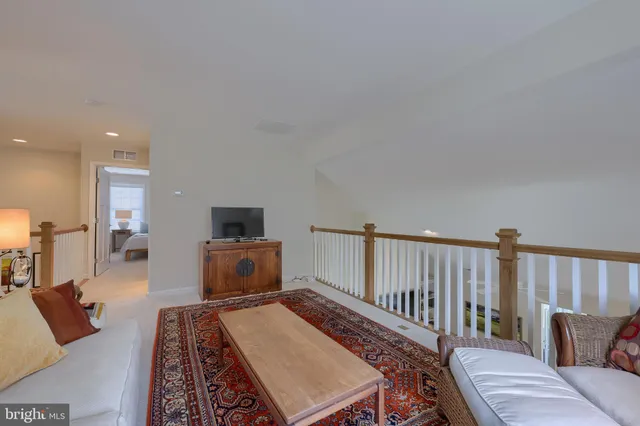 a view of a roof deck with table and chairs under an umbrella