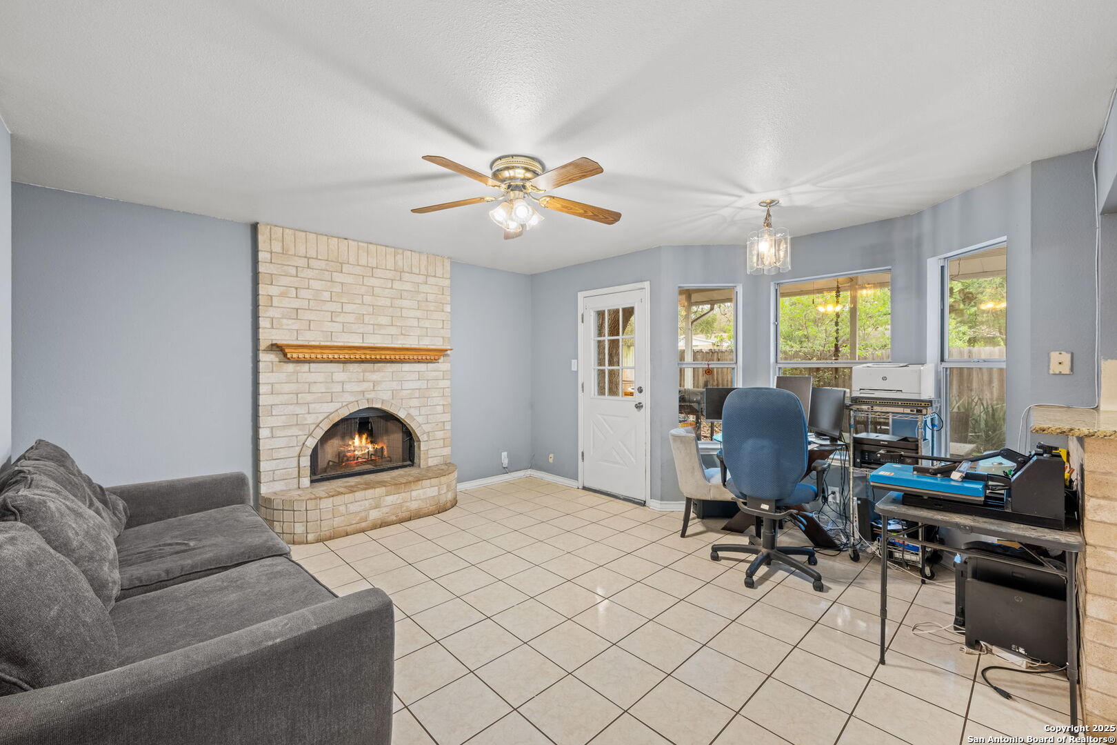 105 Golden Way Universal City, TX 78148 - Photo 17 of 23 a living room with furniture a fireplace and a floor to ceiling window