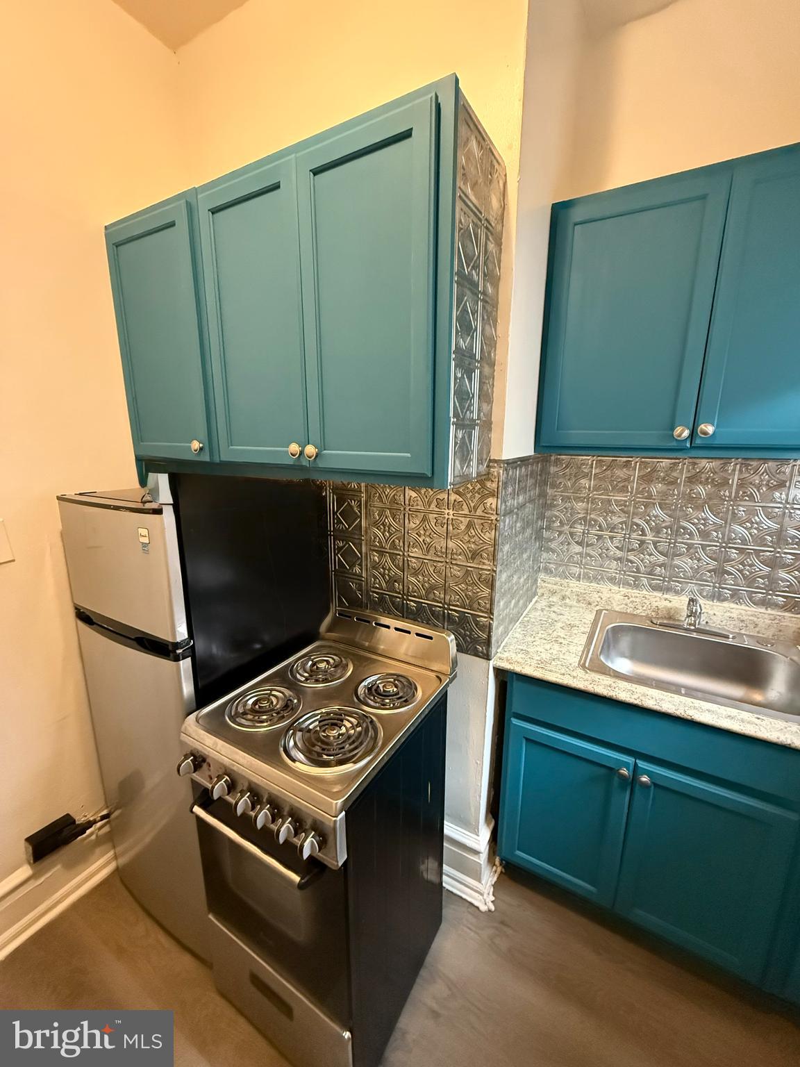 210 West State Street, Unit 3 Trenton, NJ 08608 - Photo 4 of 11 a kitchen with a sink cabinets and a stove top oven