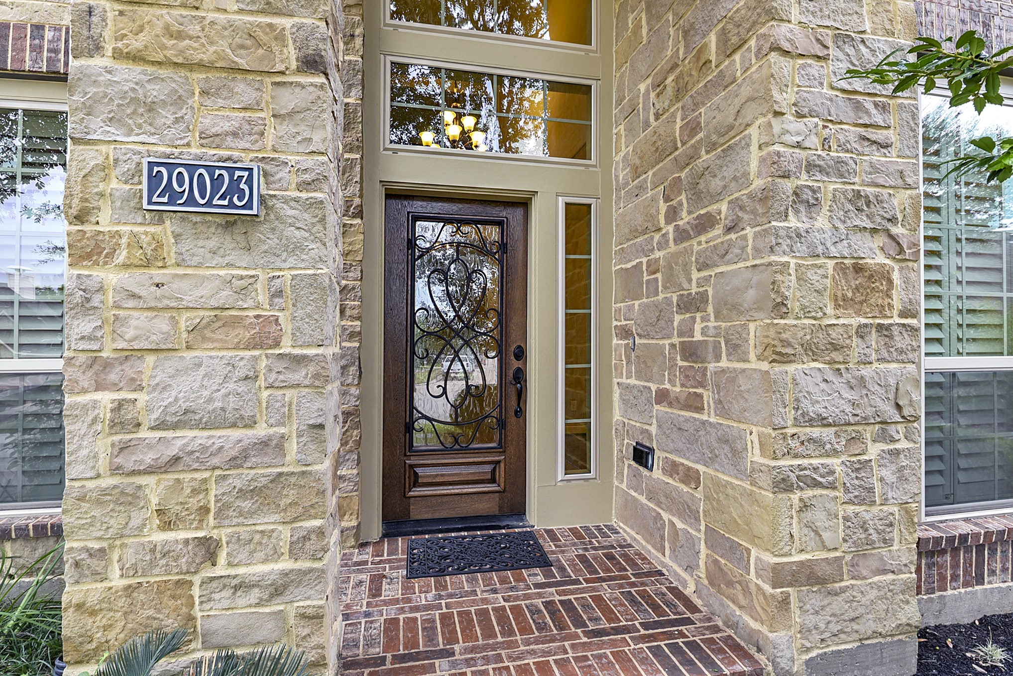29023 Powder Ridge Drive Katy, TX 77494 - Photo 5 of 50 A charming pathway leads to the front door, featuring a welcoming porch perfect for creating a cozy seating area. Beautiful brick and stone elevation adds timeless curb appeal.