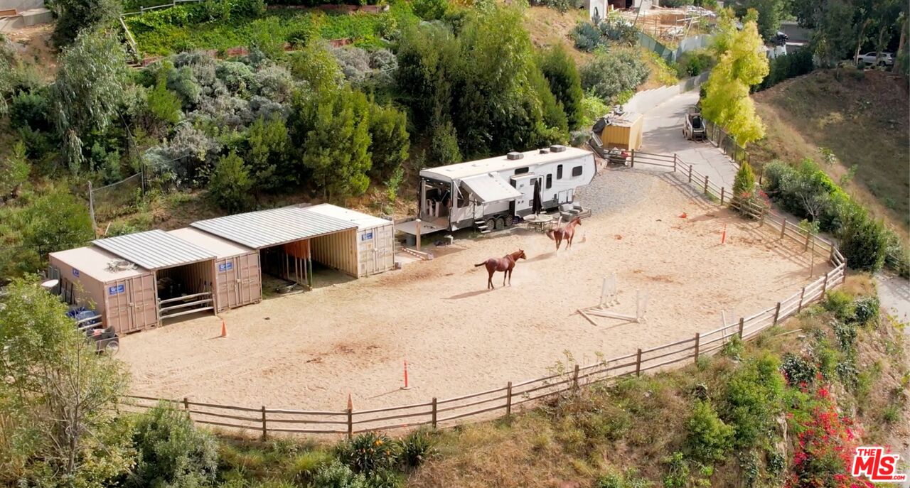 an aerial view of a yard with horses