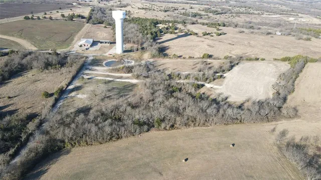 a view of dirt road with a building