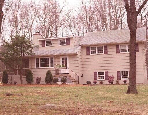 39 Highland Road Westport, CT 06880 - Photo 1 of 1 a front view of a house with a yard and garage