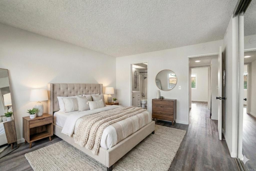 9829 Caspi Gardens Drive, Unit 6 Santee, CA 92071 - Photo 13 of 23 a bedroom with bed and wooden floor