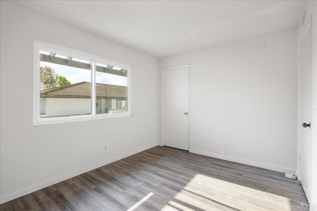 9829 Caspi Gardens Drive, Unit 6 Santee, CA 92071 - Photo 18 of 23 a view of empty room with wooden floor and fan