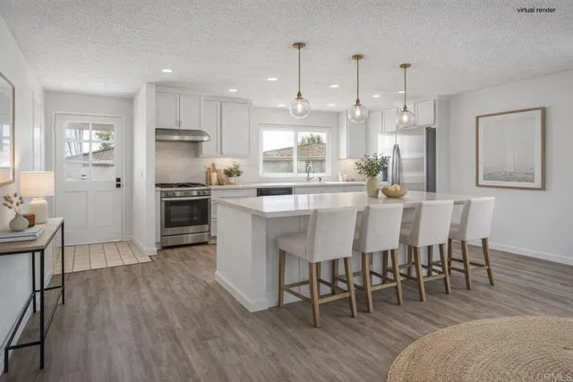 a large kitchen with kitchen island a dining table and chairs