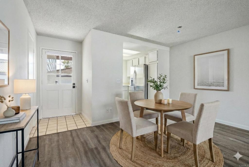 9829 Caspi Gardens Drive, Unit 6 Santee, CA 92071 - Photo 7 of 23 a view of a dining room with furniture and wooden floor