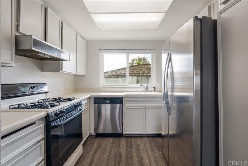 9829 Caspi Gardens Drive, Unit 6 Santee, CA 92071 - Photo 8 of 23 a kitchen with stainless steel appliances granite countertop a stove a refrigerator and a sink