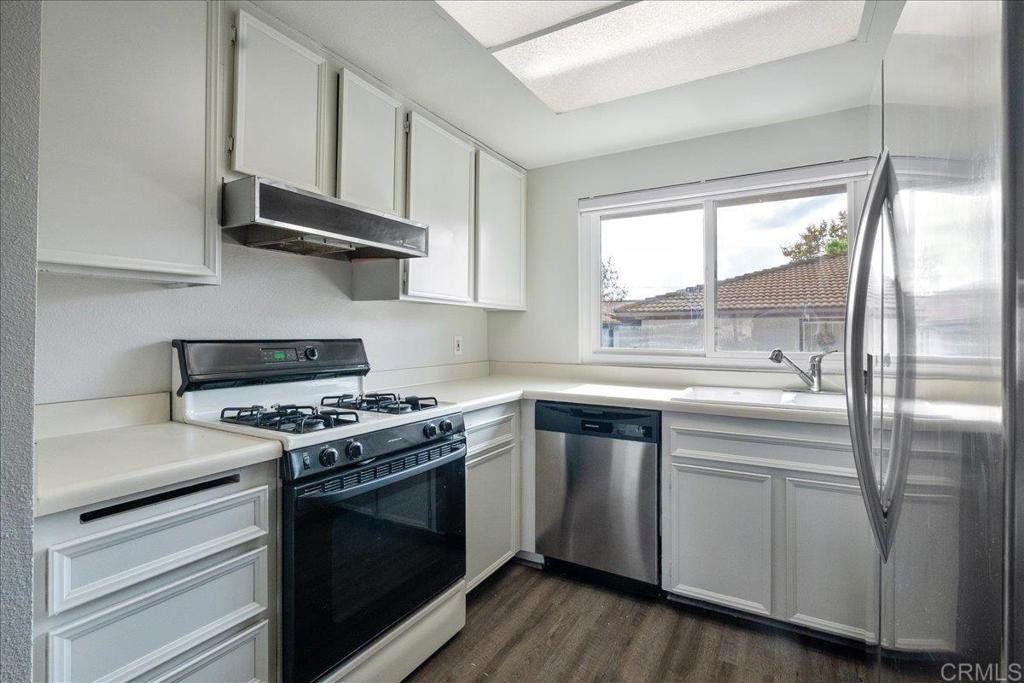 9829 Caspi Gardens Drive, Unit 6 Santee, CA 92071 - Photo 9 of 23 a kitchen with stainless steel appliances granite countertop a stove and a sink