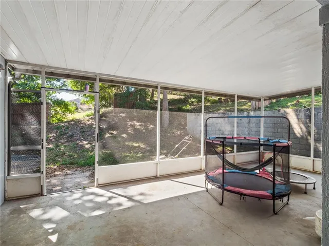 a bedroom with furniture and large windows