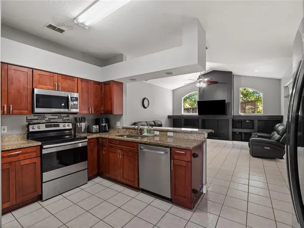a kitchen with stainless steel appliances granite countertop a sink and cabinets