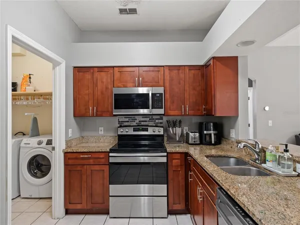 a kitchen with granite countertop a stove and a sink