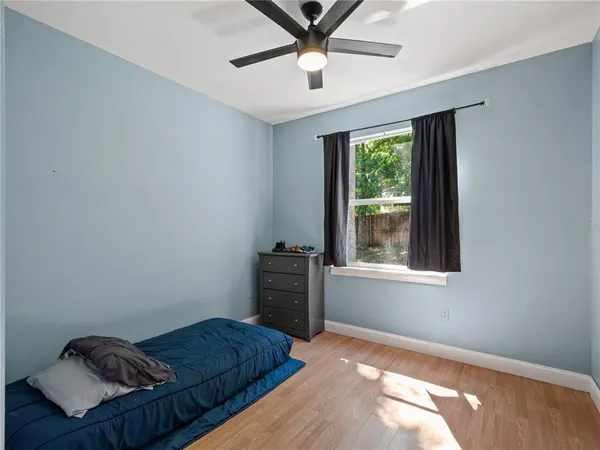 a bedroom with a bed and window