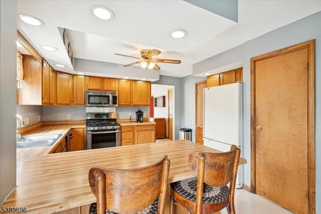 a view of a dining room with furniture and a chandelier
