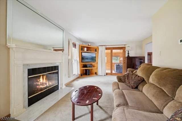 a bedroom with furniture and a large window