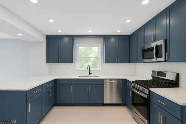 a kitchen with refrigerator and cabinets