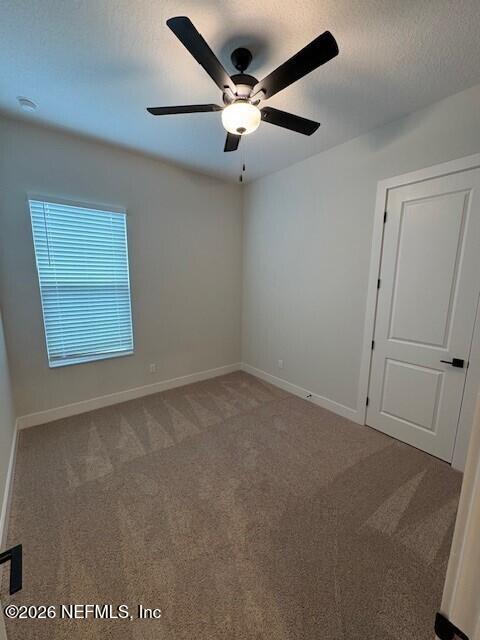8911 Ford Road Bryceville, FL 32009 - Photo 11 of 15 an empty room with a ceiling fan and window