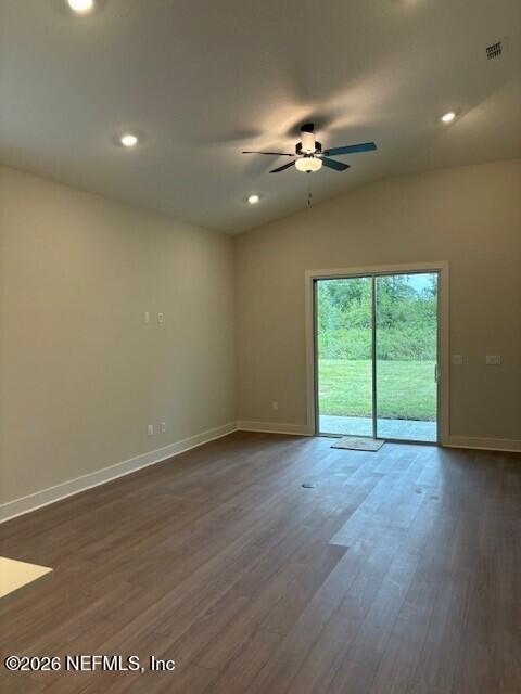 8911 Ford Road Bryceville, FL 32009 - Photo 5 of 15 an empty room with wooden floor chandelier fan and windows