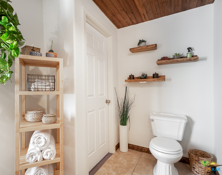 60525 Security Drive Joshua Tree, CA 92252 - Photo 16 of 39 a white toilet sitting next to a bathroom and a sink