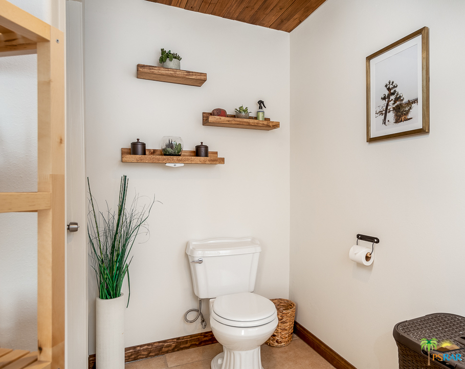 60525 Security Drive Joshua Tree, CA 92252 - Photo 17 of 39 a white toilet sitting next to a bathroom sink