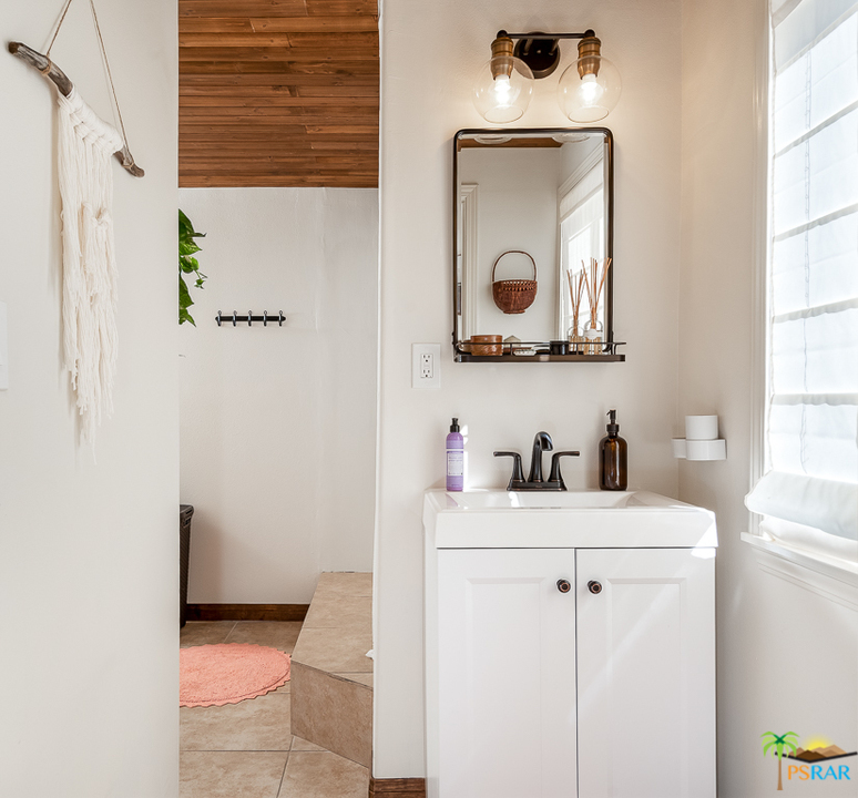 60525 Security Drive Joshua Tree, CA 92252 - Photo 18 of 39 a bathroom with a sink a vanity and a mirror
