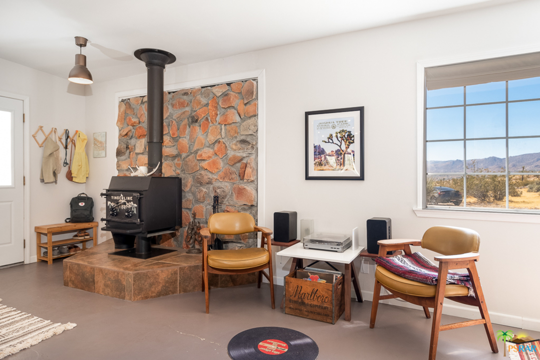 60525 Security Drive Joshua Tree, CA 92252 - Photo 3 of 39 a living room with furniture and a fireplace