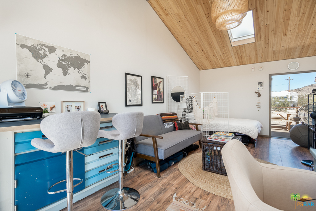 60525 Security Drive Joshua Tree, CA 92252 - Photo 24 of 39 a living room with furniture a rug and wall paintings