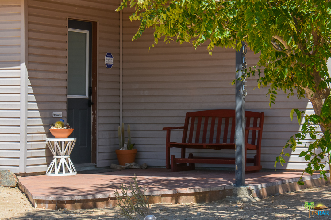 60525 Security Drive Joshua Tree, CA 92252 - Photo 25 of 39 a view of a porch with a bench