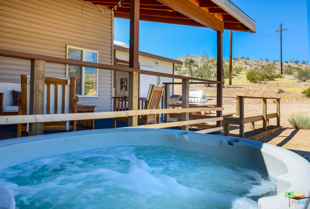60525 Security Drive Joshua Tree, CA 92252 - Photo 27 of 39 a backyard with pool table and chairs