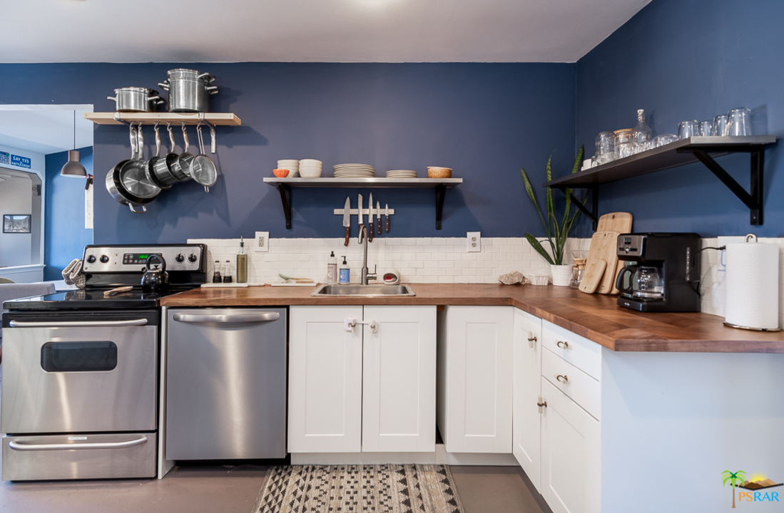 60525 Security Drive Joshua Tree, CA 92252 - Photo 5 of 39 a kitchen with stainless steel appliances granite countertop a sink stove and refrigerator