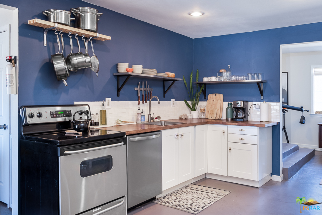 60525 Security Drive Joshua Tree, CA 92252 - Photo 6 of 39 a kitchen with stainless steel appliances a sink and cabinets