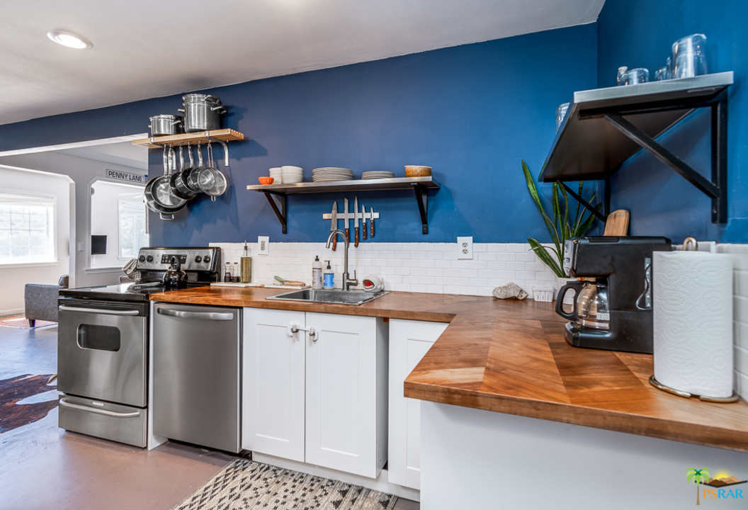 60525 Security Drive Joshua Tree, CA 92252 - Photo 7 of 39 a kitchen with stainless steel appliances granite countertop a sink and cabinets