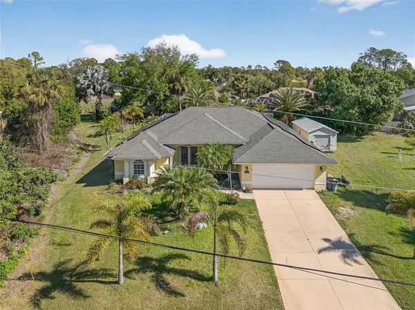 an aerial view of a house with a yard