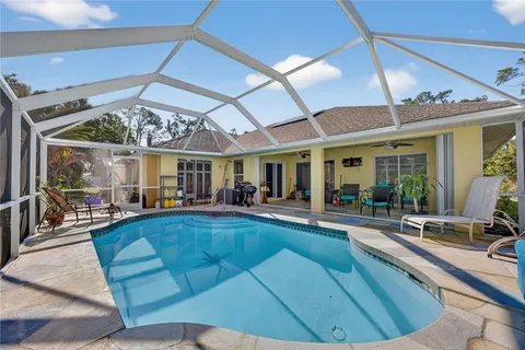 a view of a patio with swimming pool table and chairs
