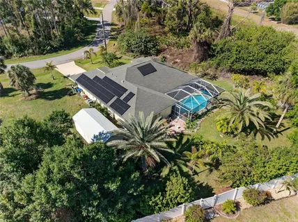 an aerial view of a house with a yard and garden