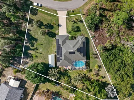 an aerial view of house with a yard