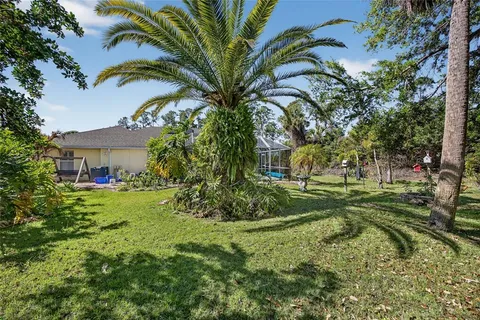 a view of a house with a yard and potted plants