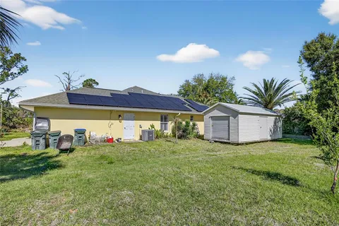 a view of a house with a yard and plants