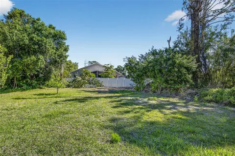 a view of a big yard with large trees