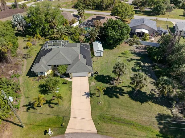 an aerial view of a house with a yard