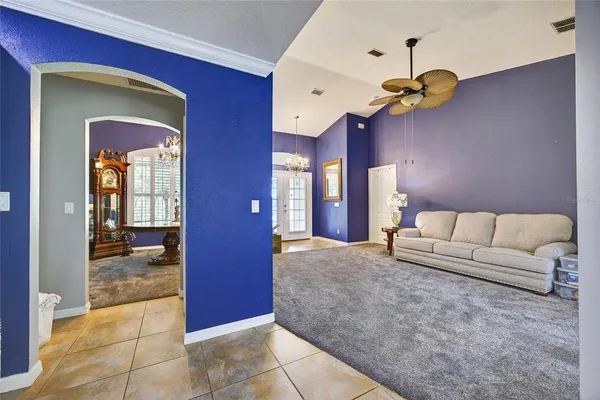 a living room with a couch and chandelier