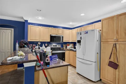 a kitchen with stainless steel appliances a refrigerator sink and white cabinets