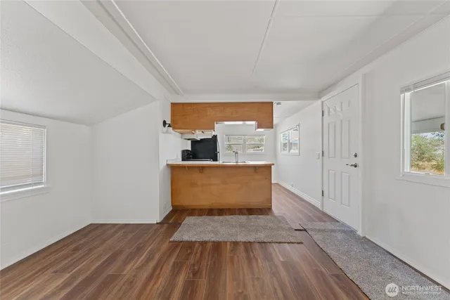 a view of a bedroom with wooden floor and front door