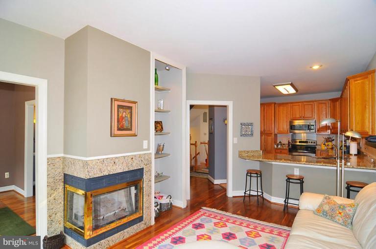 9404 Regency Crest Drive Vienna, VA 22181 - Photo 12 of 30 a living room with stainless steel appliances furniture a rug and a kitchen view