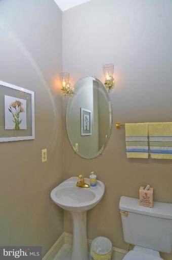9404 Regency Crest Drive Vienna, VA 22181 - Photo 14 of 30 a bathroom with a sink mirror and toilet