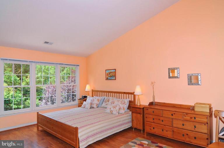 9404 Regency Crest Drive Vienna, VA 22181 - Photo 19 of 30 a bedroom with a bed and a window with chair