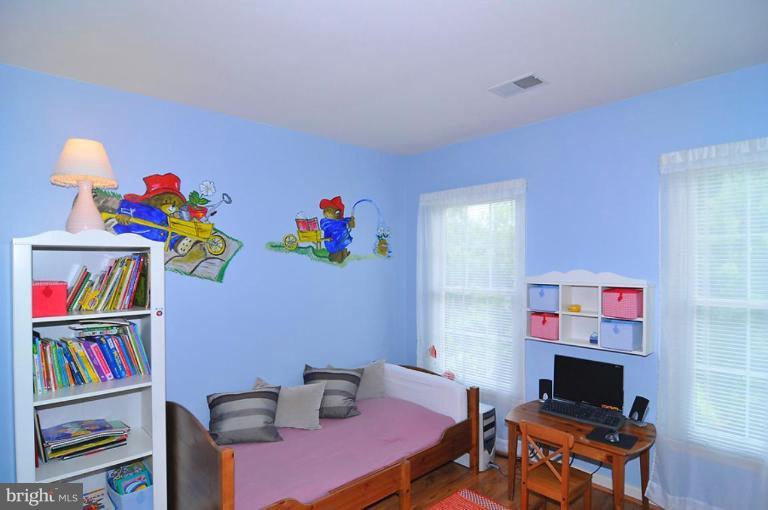 9404 Regency Crest Drive Vienna, VA 22181 - Photo 25 of 30 a living room with furniture and a bookshelf