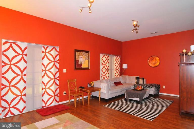 9404 Regency Crest Drive Vienna, VA 22181 - Photo 26 of 30 a living room with blue lights with furniture and rug