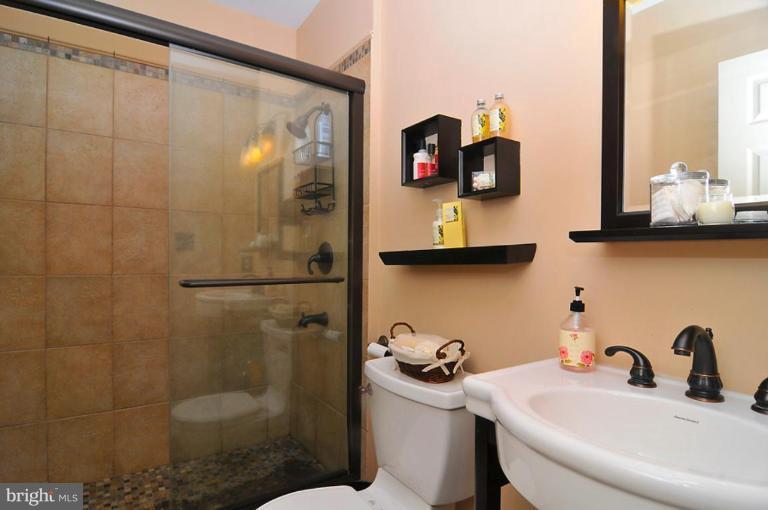 9404 Regency Crest Drive Vienna, VA 22181 - Photo 29 of 30 a bathroom with a toilet sink and mirror