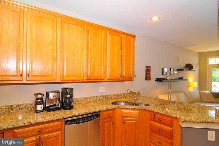 9404 Regency Crest Drive Vienna, VA 22181 - Photo 9 of 30 a kitchen with stainless steel appliances granite countertop a sink stove and cabinets